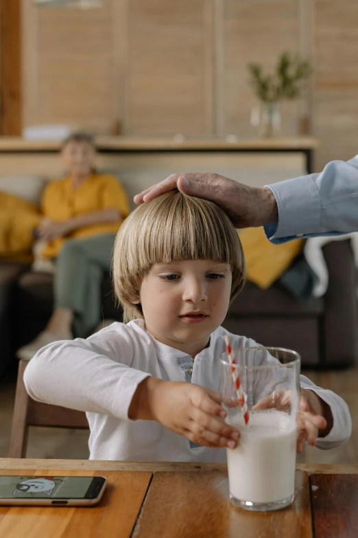 a little boy sitting at a table with a glass of milk, pexels contest winner, hyperrealism, caring fatherly wide forehead, vfx, greeting hand on head, healthcare
