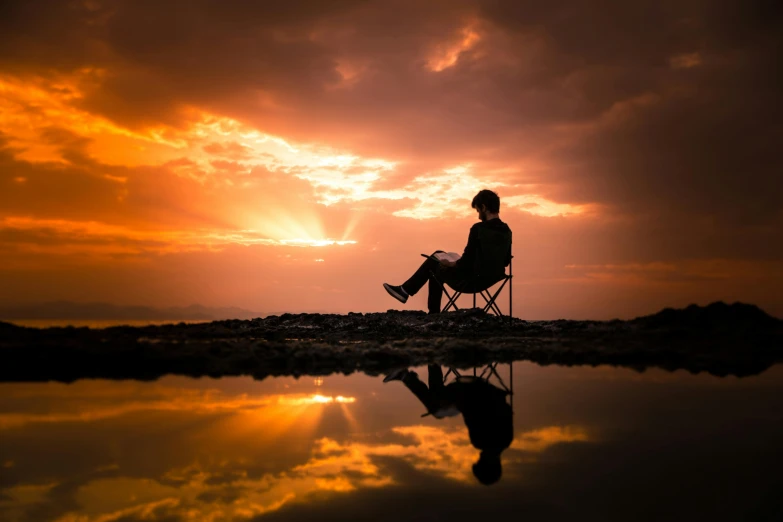 a person sitting in a chair at sunset, pexels contest winner, marvellous reflection of the sky, paul barson, resting, professional photo