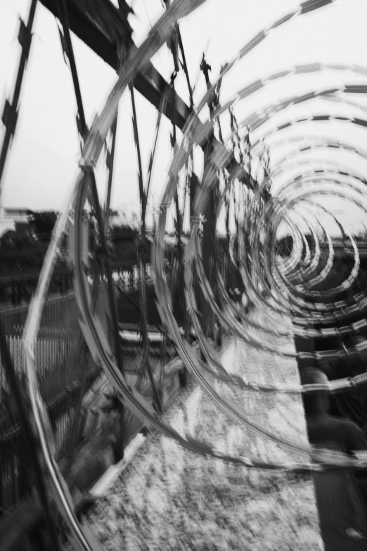 a black and white photo of a bunch of razors, a black and white photo, inspired by Cornelia Parker, abstract illusionism, water wheel, holga, made of wire, ( ( photograph ) )