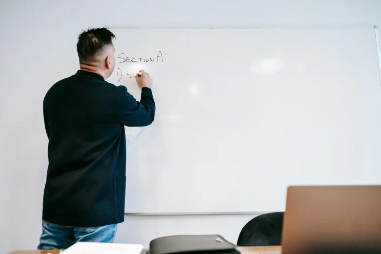 a man writing on a whiteboard in a classroom, by Robbie Trevino, minimalistic art, lachlan bailey, background image, presentation