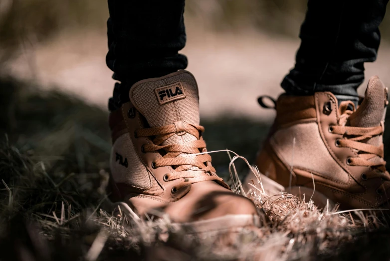 a close up of a person's shoes in the grass, an album cover, inspired by Elsa Bleda, trending on pixabay, visual art, caramel. rugged, worksafe. instagram photo, standing in a desert, streetwear