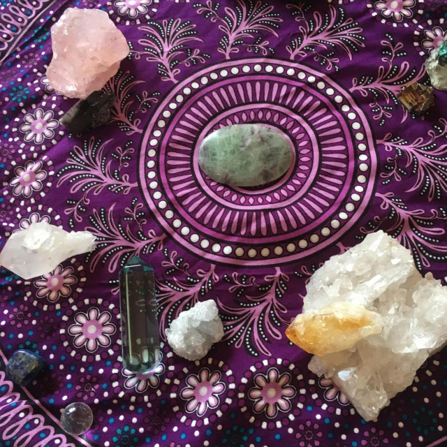 a table topped with lots of different types of crystals, an album cover, by Alice Mason, pexels, green and pink fabric, intricate ground stone, health spa and meditation center, highly detailed # no filter
