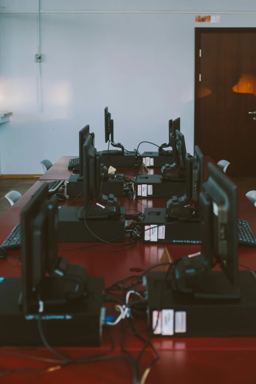 a group of computers sitting on top of a red desk