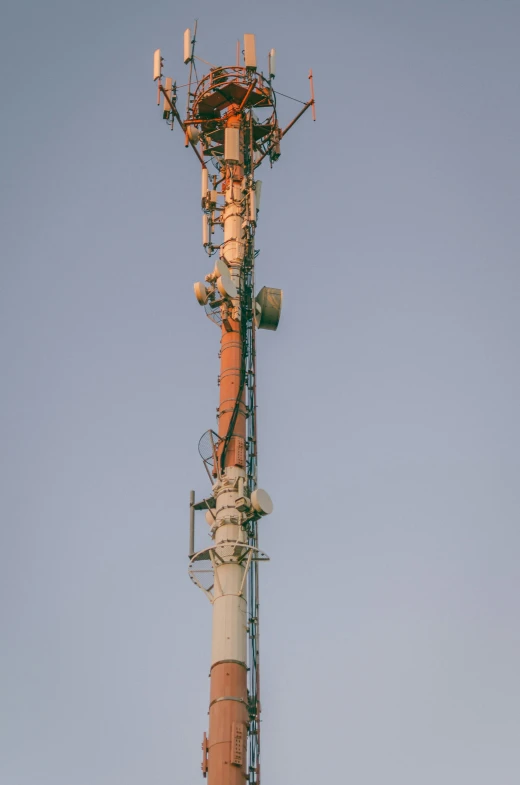 a cell phone tower against a blue sky, a portrait, unsplash, postminimalism, faded and dusty, 2 0 0 mm telephoto, well worn, various posed