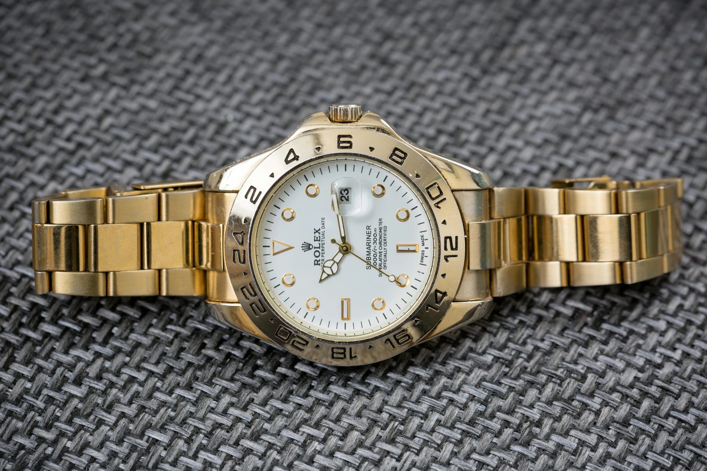 a close up of a watch on a table, a portrait, by Kev Walker, rolex, shiny gold, thumbnail, gold and white