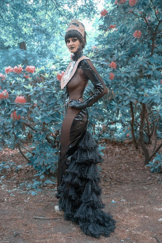 a woman in a long dress posing for a picture, an album cover, inspired by Herb Ritts, unsplash, autochrome photograph, skintight leather clothes, in garden, elaborate costume