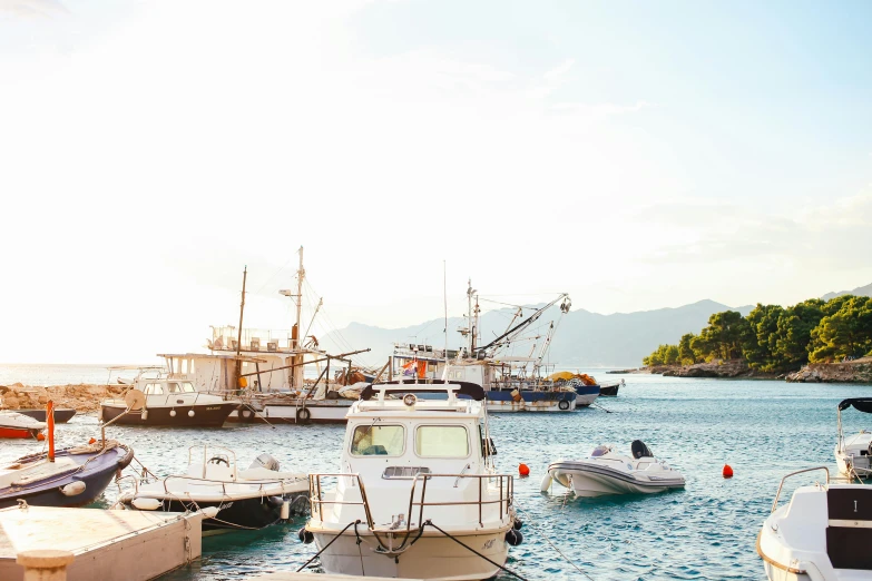 a number of boats in a body of water, by Niko Henrichon, pexels contest winner, boka, port scene background, al fresco, brightly lit