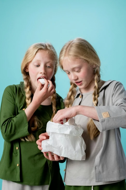 a couple of young girls standing next to each other, inspired by Frieke Janssens, shutterstock contest winner, happening, tiny people devouring food, made of lab tissue, eggs, 15081959 21121991 01012000 4k