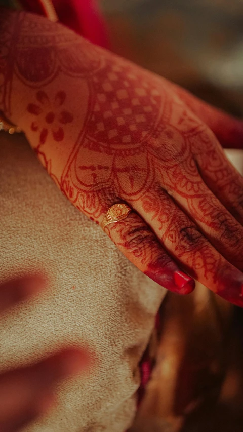 a close up of a person's hand with henna on it, pexels, square, wedding, thumbnail, red birthmark