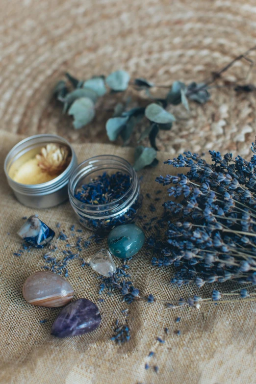 a bunch of dried flowers sitting on top of a table, sapphire, products shot, lavender, facial