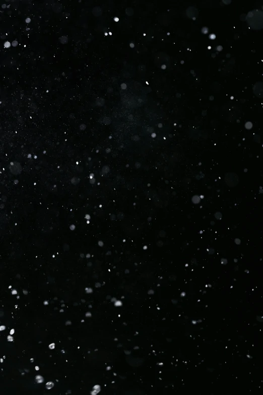 a man riding a snowboard down a snow covered slope, an album cover, reddit, light and space, black sky full of stars, low quality footage, black octane render, glitter gif