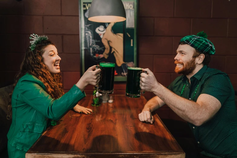 a couple of people that are sitting at a table, irish, cheers, lachlan bailey, profile image