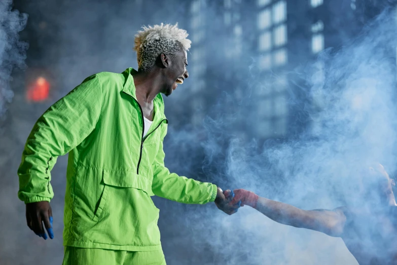 a man in a green jacket shaking another man's hand, by Lee Gatch, pexels contest winner, die antwoord yolandi visser, adut akech, with dramatic lighting, light green mist