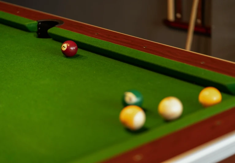 a close up of a pool table with balls on it, a portrait, by Elsa Bleda, unsplash, fan favorite, medium shot angle, high angle shot, photorealistic cinematic render