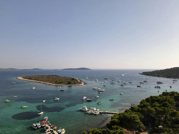 a large body of water filled with lots of boats, pexels contest winner, mediterranean island scenery, hziulquoigmnzhah, ignant, islands on horizon