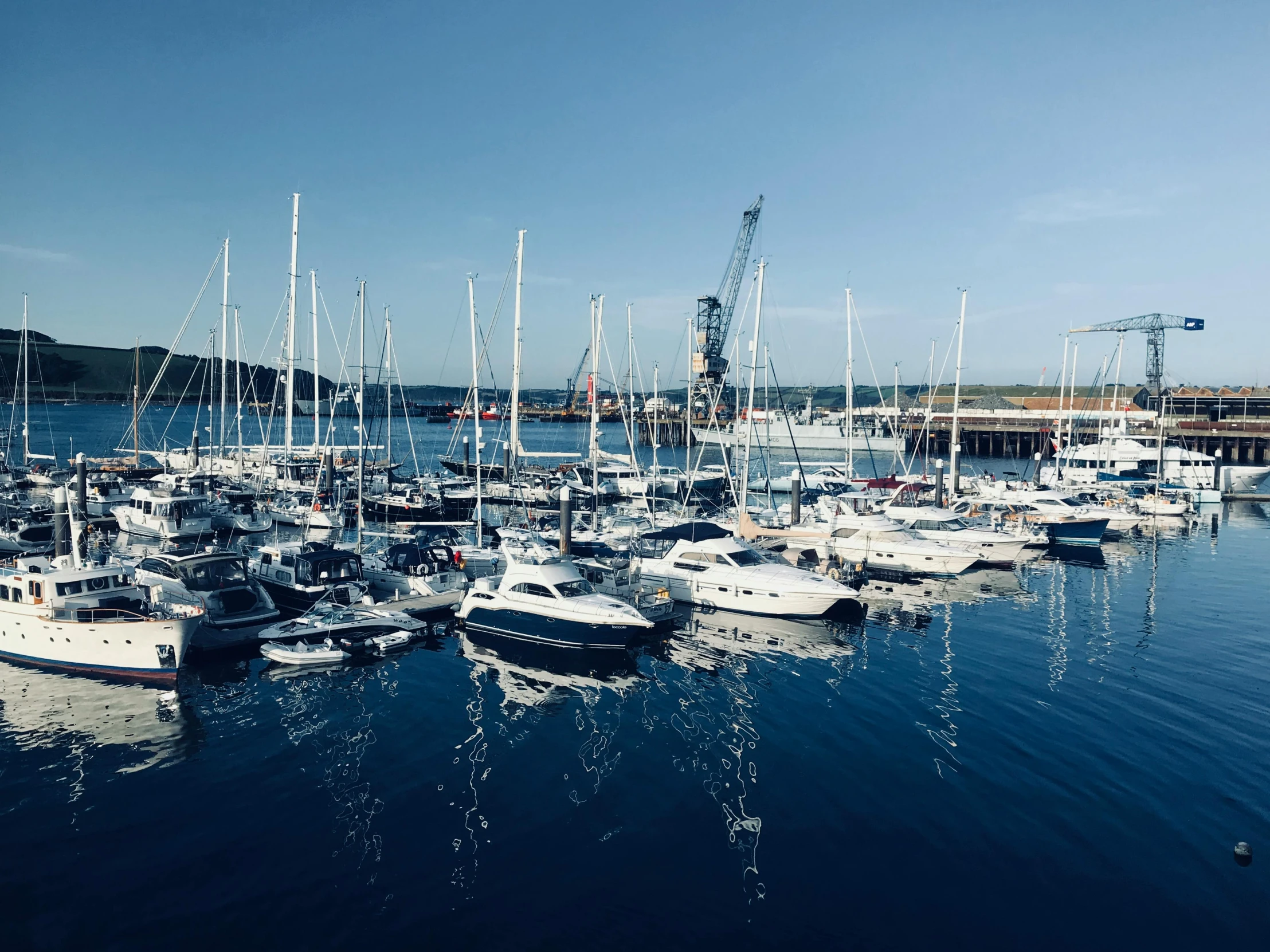 a harbor filled with lots of boats under a blue sky, a photo, pexels contest winner, holywood scene, profile image, thumbnail, ignant