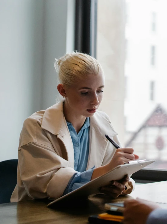 a couple of people that are sitting at a table, pexels contest winner, academic art, girl with short white hair, holding a clipboard, profile image, white coat