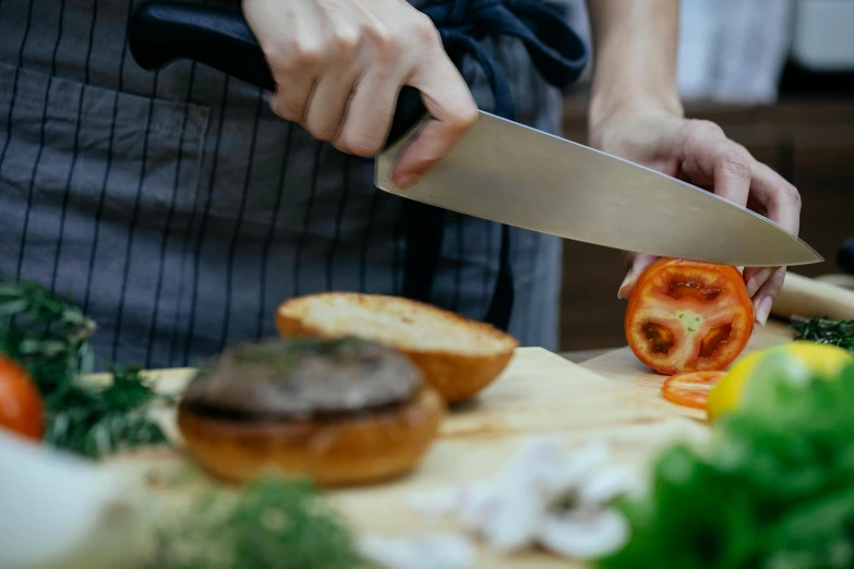 a person cutting a tomato on a cutting board, pexels contest winner, holding toasted brioche bun, chef platypus, knives, panoramic shot