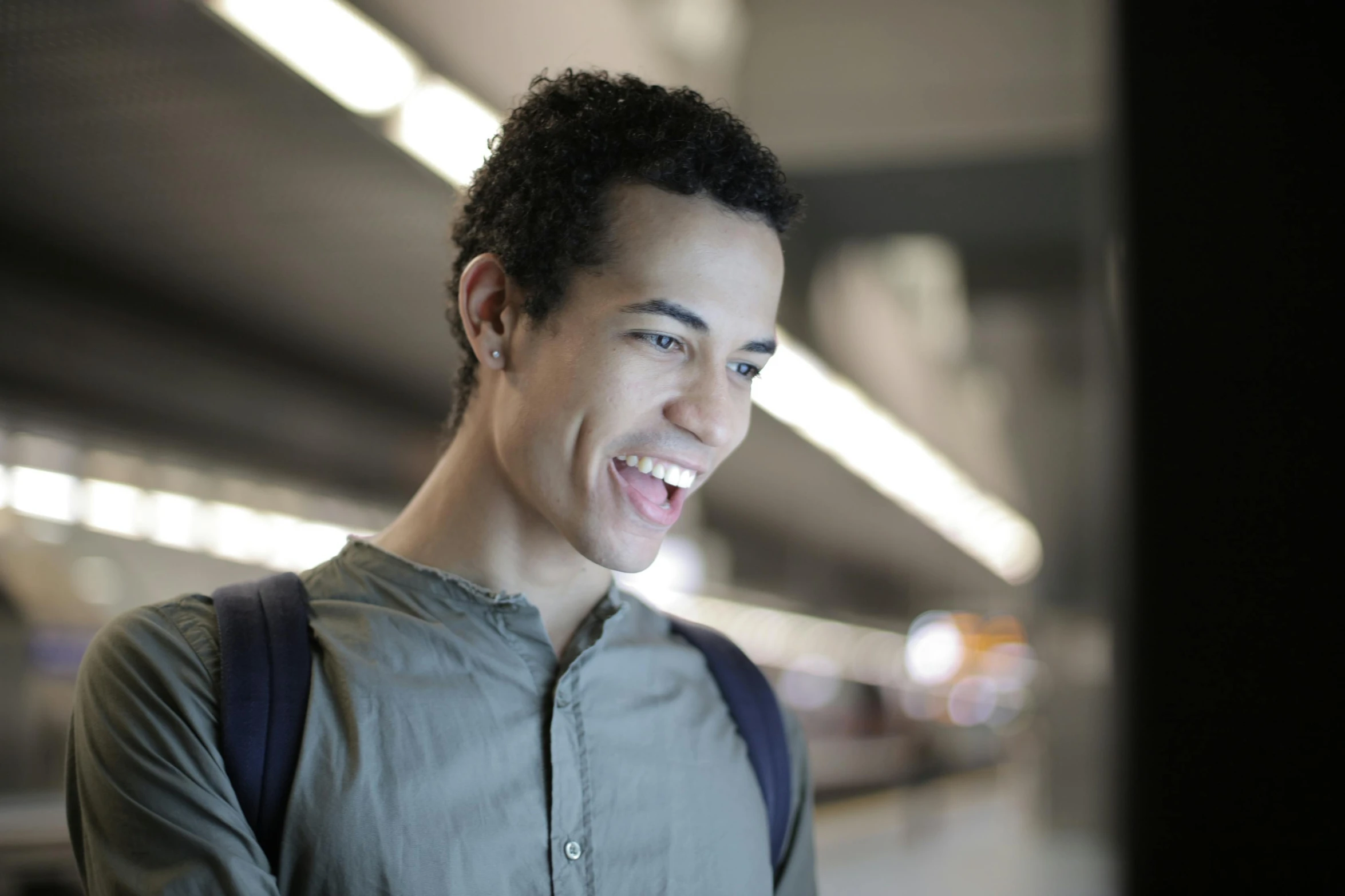 a close up of a person on a cell phone, by Washington Allston, pexels contest winner, happening, smiling male, in a subway, nonbinary model, mixed race