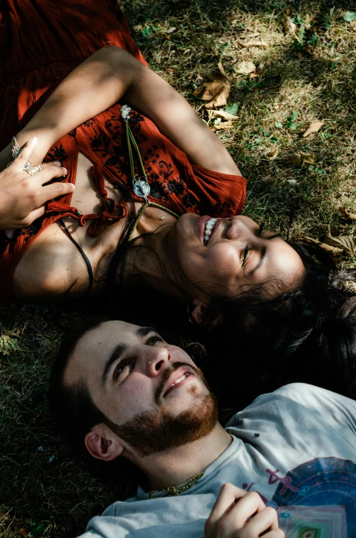 a man and a woman laying on the ground, pexels contest winner, renaissance, 15081959 21121991 01012000 4k, dreaming bodies, smiling down from above, hispanic