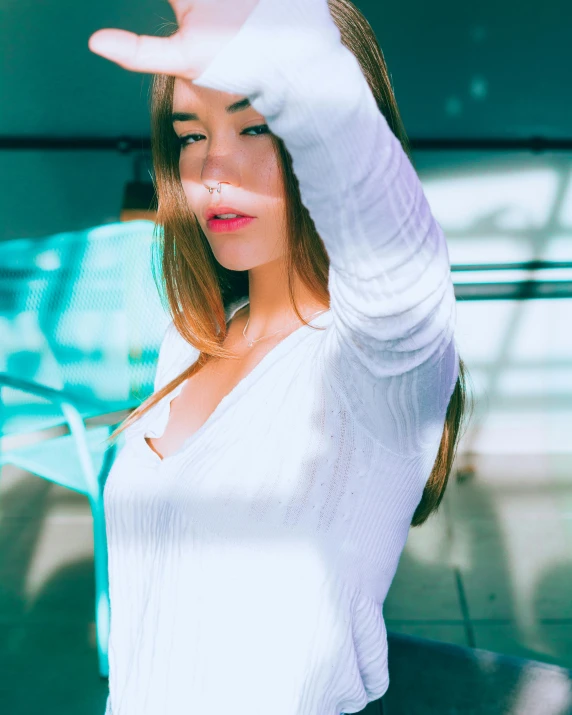 a woman making a stop sign with her hand, a polaroid photo, inspired by Elsa Bleda, unsplash, happening, wearing white leotard, :: madison beer, discreet lensflare, transparent vibrant glowing skin