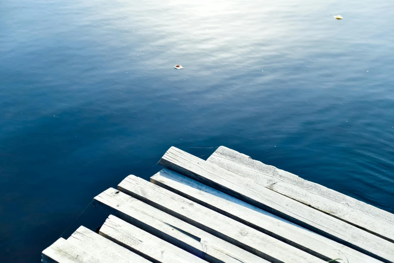 a wooden dock in the middle of a body of water, an album cover, inspired by Mór Than, pexels contest winner, minimalism, picton blue, ignant, morning sunlight, weightless
