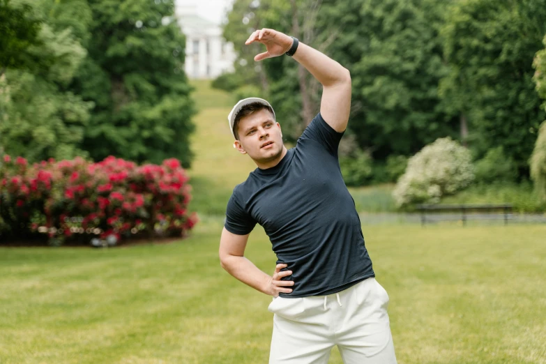 a man throwing a frisbee in a park, an album cover, by Sebastian Spreng, unsplash, renaissance, yung lean, showing off his muscles, wearing a dark blue polo shirt, dasha taran