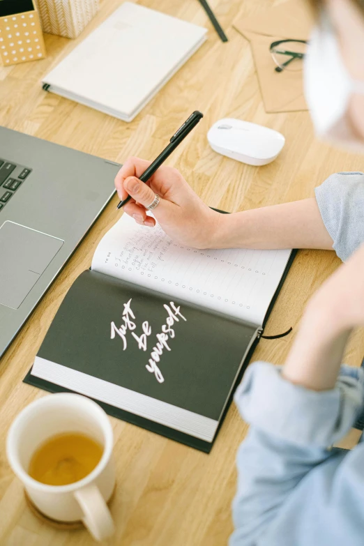 a woman sitting at a desk writing on a notebook, with japanese inspiration, promo image, computer, thumbnail