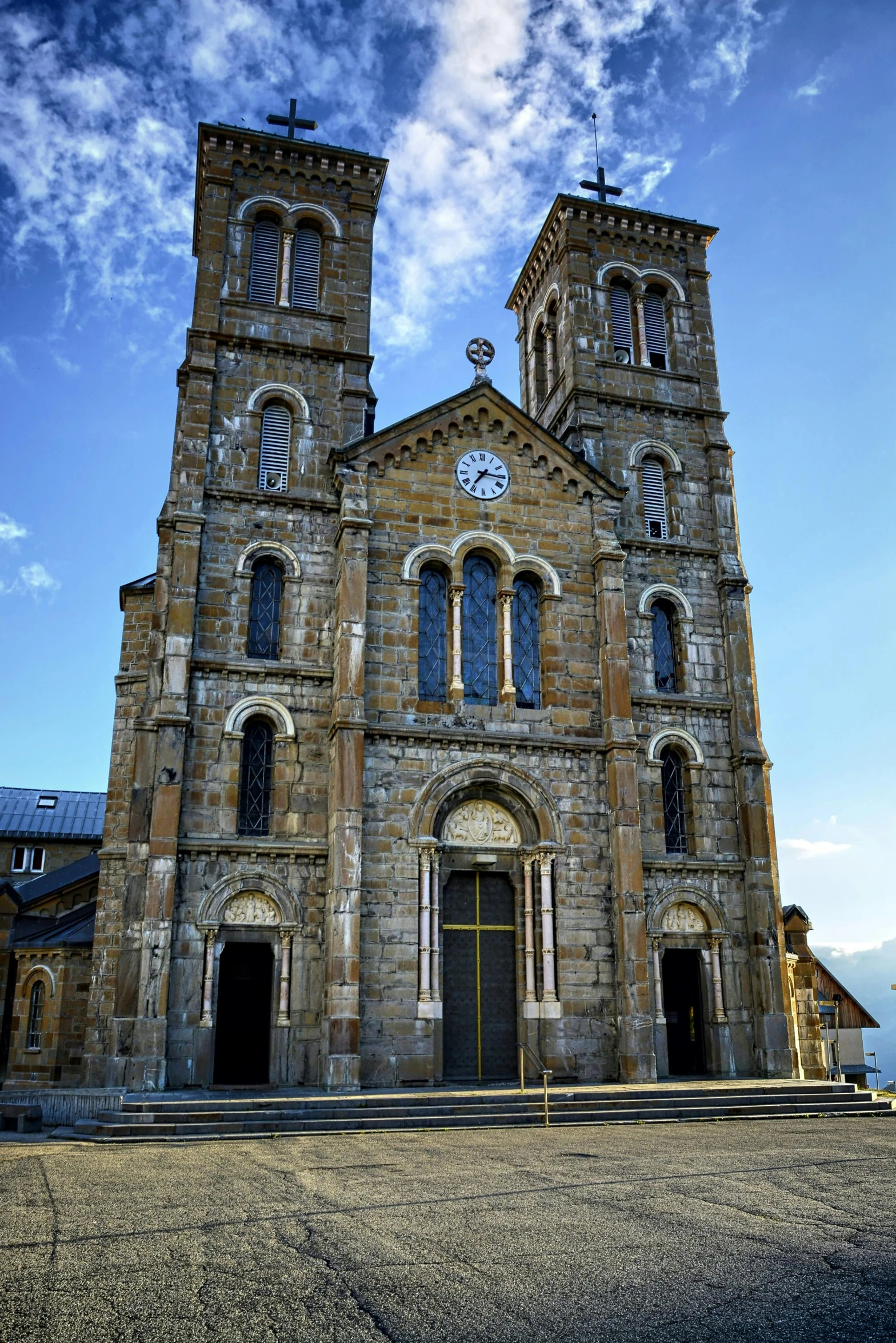 a large stone church with a clock tower, romanesque, majestic masterpiece, view from front, wellington, cloicsonne