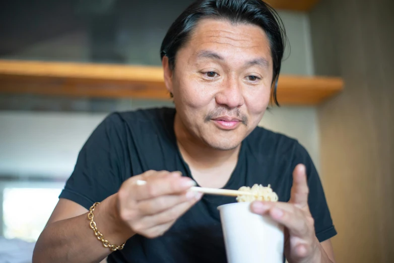 a man eating a bowl of noodles with chopsticks, a portrait, shin hanga, profile image, darren quach, portrait image