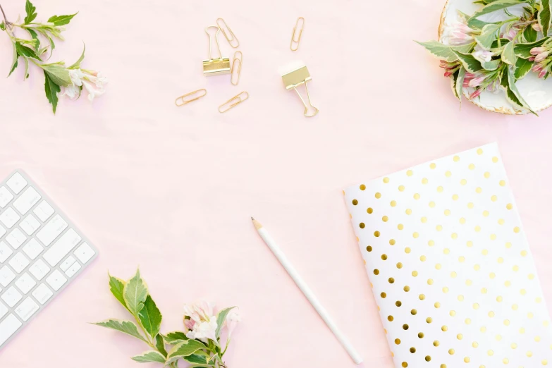 a computer keyboard sitting on top of a pink desk, gold decorations, thumbnail, background image, pencil and paper