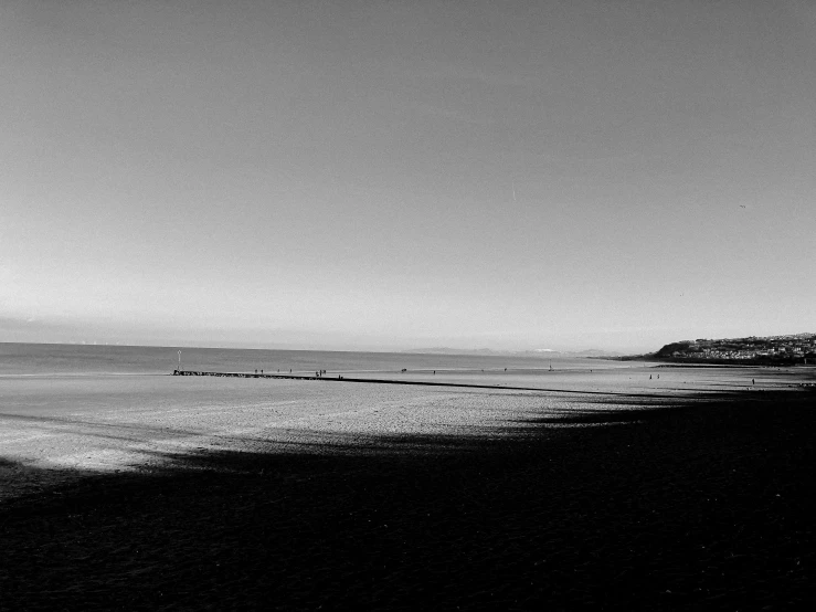 a black and white photo of a beach, by Ian Fairweather, sunny morning, calm evening, frozen sea, uploaded