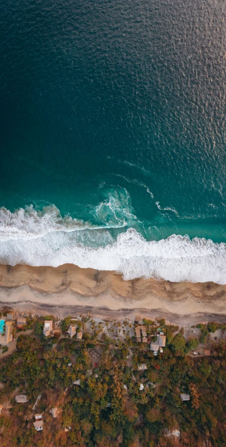 an aerial view of a beach and ocean, by Robbie Trevino, pexels contest winner, landslides, oceanside, katey truhn, tan