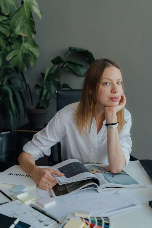 a woman sitting at a desk in front of a laptop computer, a portrait, by Grytė Pintukaitė, architect studio, next to a plant, vp of marketing, alexey egorov