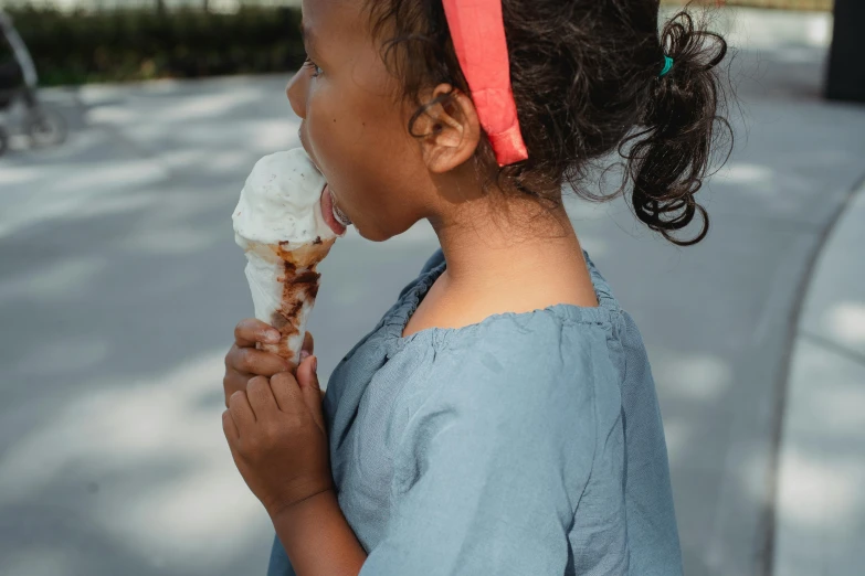 a little girl eating an ice cream cone, pexels contest winner, looking her shoulder, 15081959 21121991 01012000 4k, indian girl with brown skin, ice blue