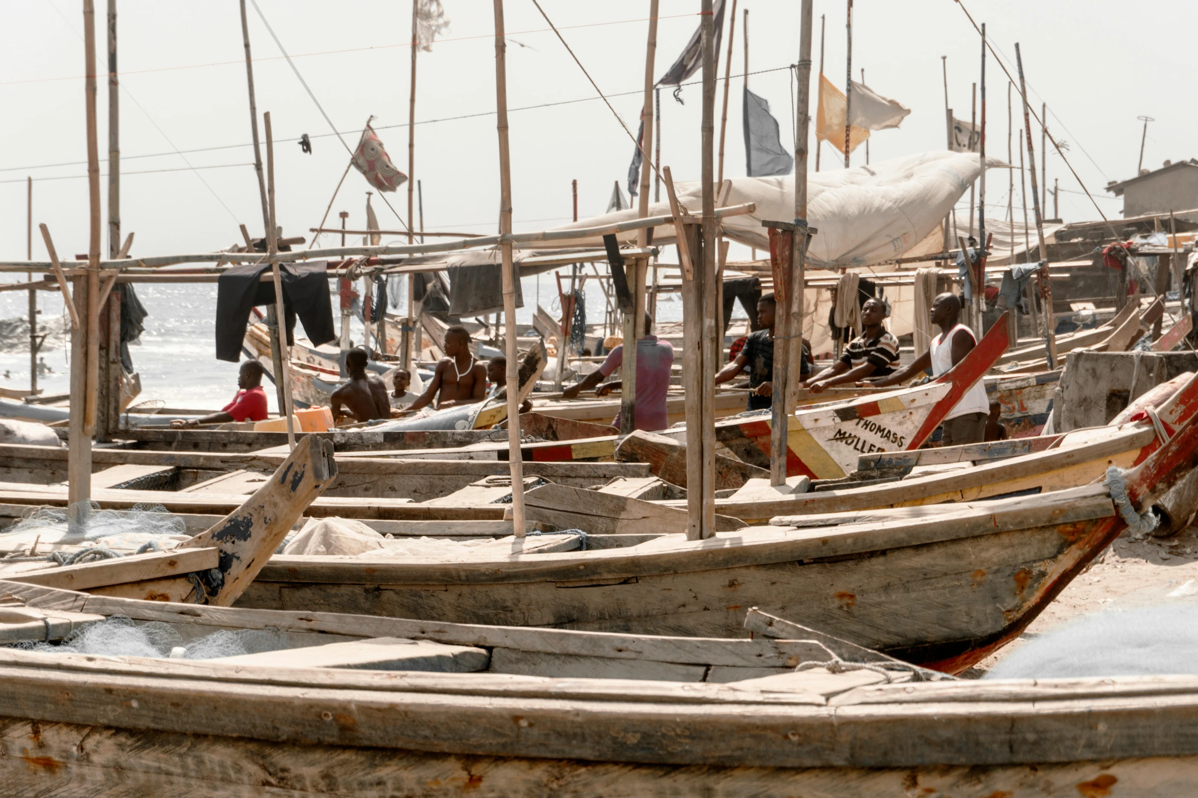 a group of boats sitting on top of a sandy beach, trending on unsplash, process art, timbuktu, fish market, thumbnail, high quality photo