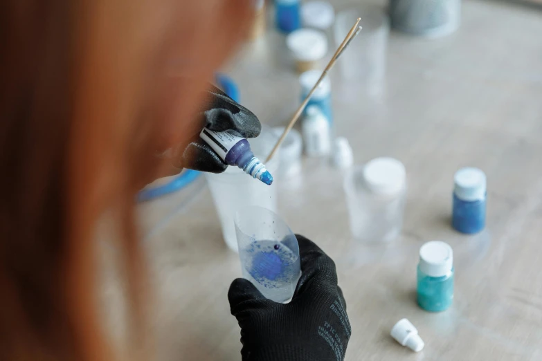 a close up of a person holding a bottle of liquid, an airbrush painting, scientific glassware, phthalo blue, thumbnail