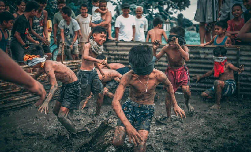 a group of boys playing in the mud, a colorized photo, pexels contest winner, philippines, in an arena pit, instagram story, tribe members chasing