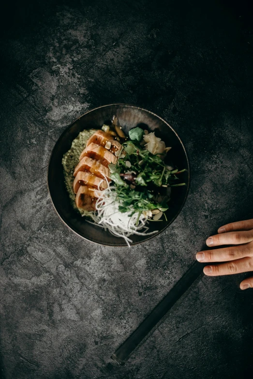 a person holding a knife over a bowl of food, inspired by Nishida Shun'ei, pexels contest winner, black textured, grilled chicken, lush vista, ramen