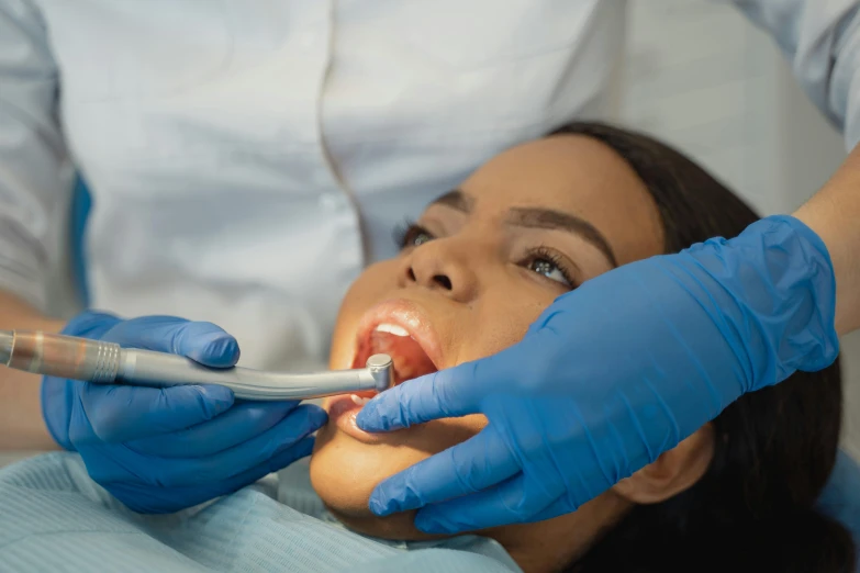 a woman getting her teeth examined by a dentist, pexels contest winner, fantastic realism, manly, blue, biting lip, coronation