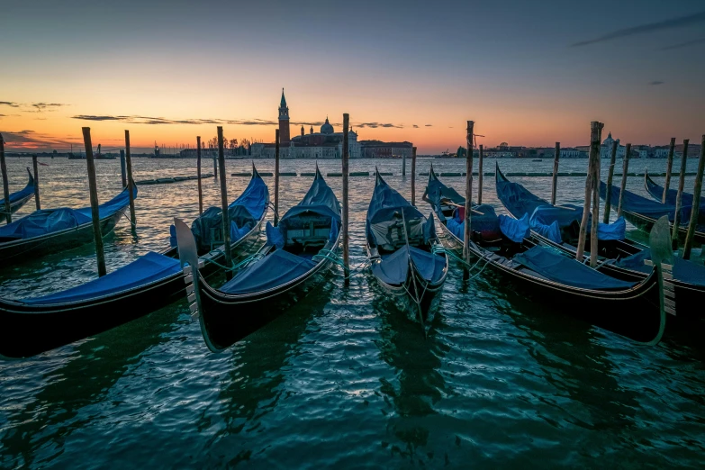 a group of gondolas sitting on top of a body of water, by Carlo Martini, pexels contest winner, crepuscule, blue and green water, thumbnail, brown