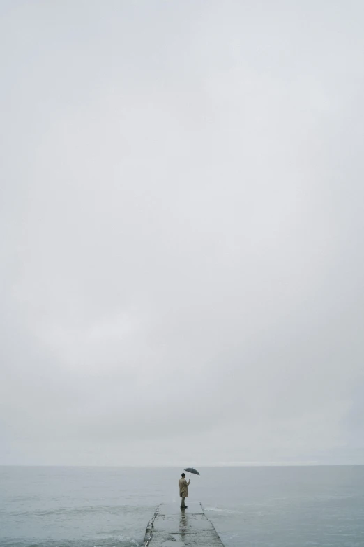 a person standing on a pier with an umbrella, a minimalist painting, inspired by Andreas Gursky, postminimalism, pure white hazy overcast sky, 35mm —w 1920 —h 1080, snowstorm ::5, high res photograph