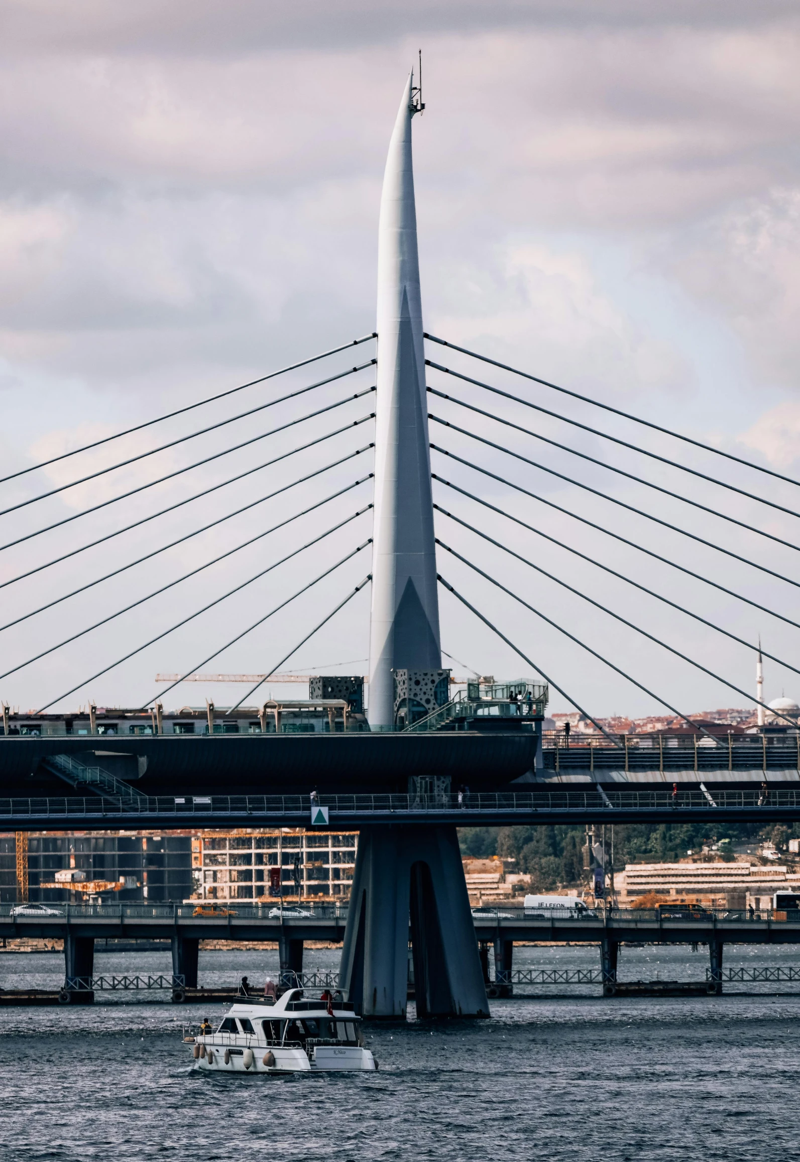 a boat on a body of water near a bridge, by Alessandro Allori, pexels contest winner, modernism, gigantic tower, high technical detail, calatrava, high resolution photo