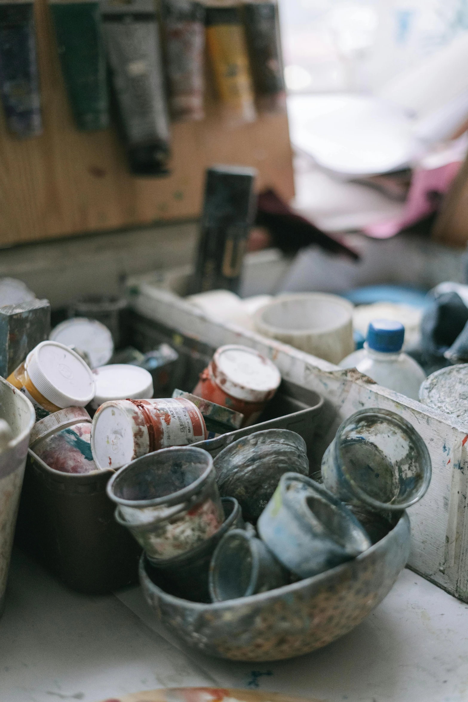 a bunch of paint cans sitting on top of a table, a picture, arbeitsrat für kunst, mineral collections, chipped paint, in a workshop, promo image