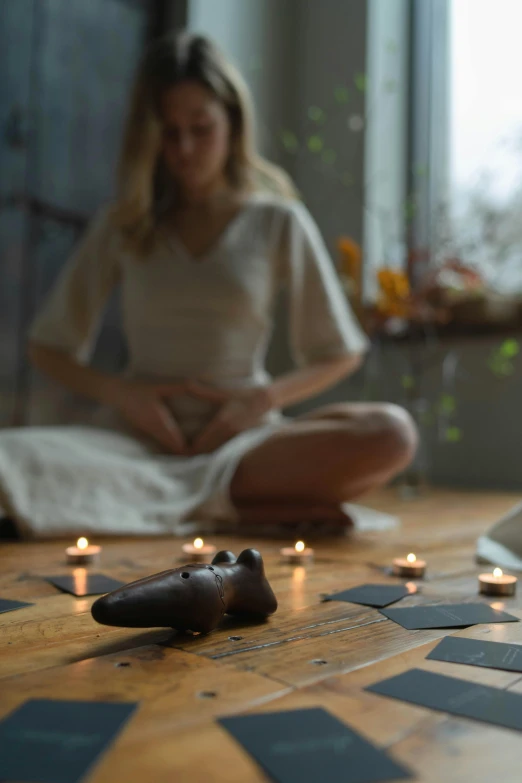 a woman sitting on the floor surrounded by candles, a statue, inspired by Elsa Bleda, healing pods, profile image, whirling, medium close shot