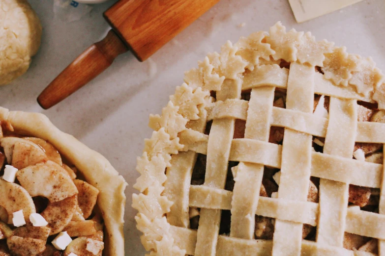 a couple of pies sitting on top of a table, trending on pexels, renaissance, weave, lattice, ribbon, utility