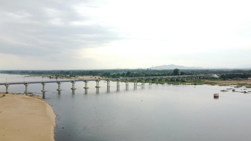 a bridge over a body of water under a cloudy sky, a picture, hurufiyya, indore, high view, hyperdetailed!, high-quality photo