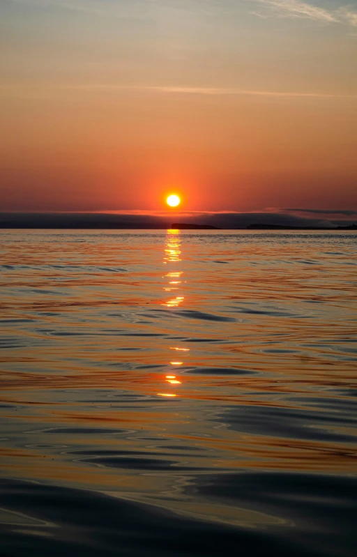 the sun is setting over a body of water, by Linda Sutton, pexels, orkney islands, northern finland, july 2 0 1 1, high quality photo