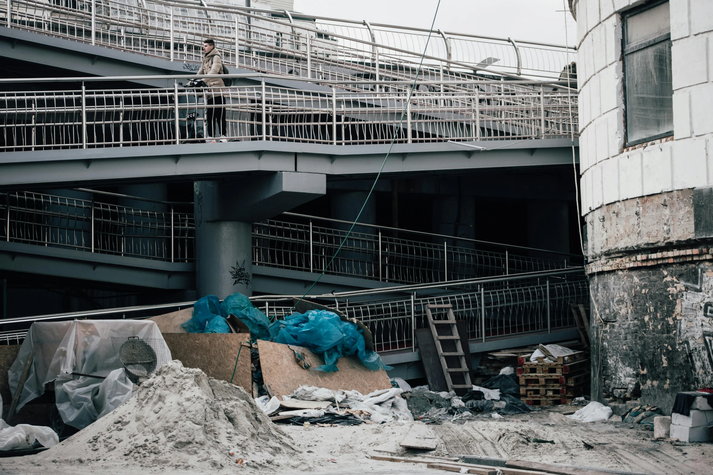 a man riding a skateboard on top of a ramp, a portrait, inspired by Zhang Kechun, unsplash, rubble everywhere, 000 — википедия, construction yard, grey