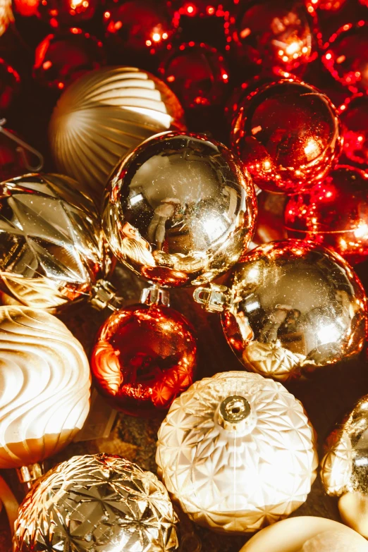 a pile of christmas ornaments sitting on top of a table, golden dappled lighting, silver gold red details, zoomed in, pearlescent